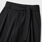 Black men's wide-leg pleated trousers waistband and pleat detail