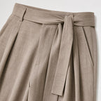 Khaki men's wide-leg pleated trousers waistband and pleat detail