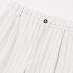 Men's white pinstripe pleated trousers waistband detail