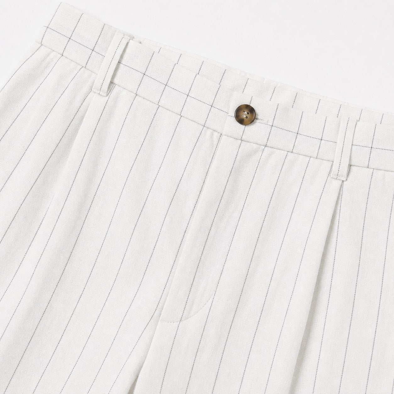Men's white pinstripe pleated trousers waistband detail